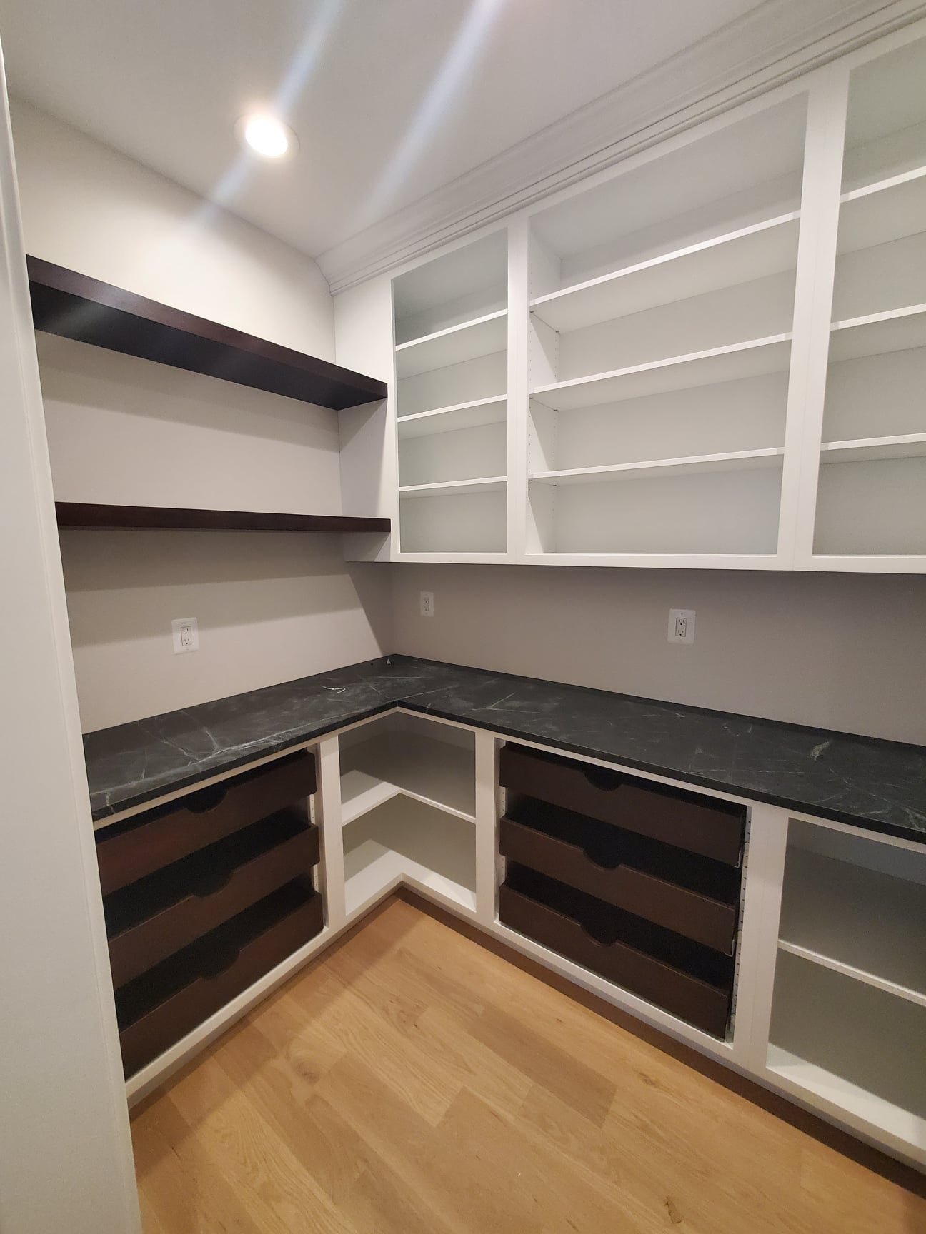 Custom pantry storage detail with deep drawers and adjustable shelving