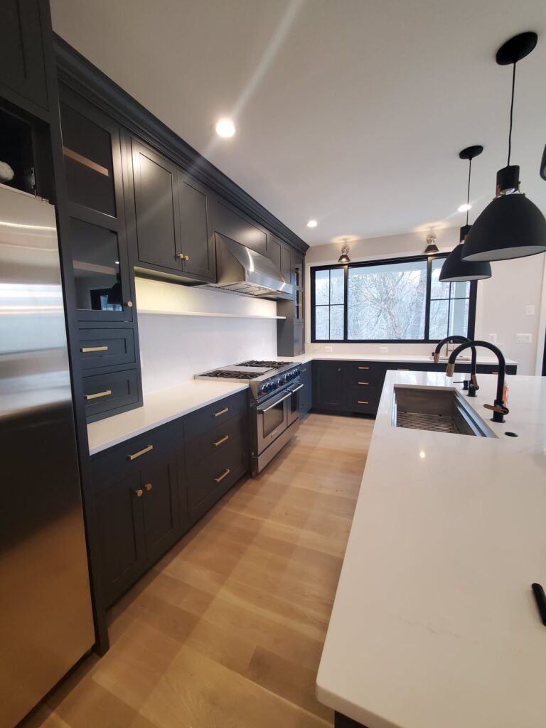 Custom kitchen in Towson, MD with navy cabinetry, quartz island, and modern lighting by Choice Custom Cabinetry & Design.
