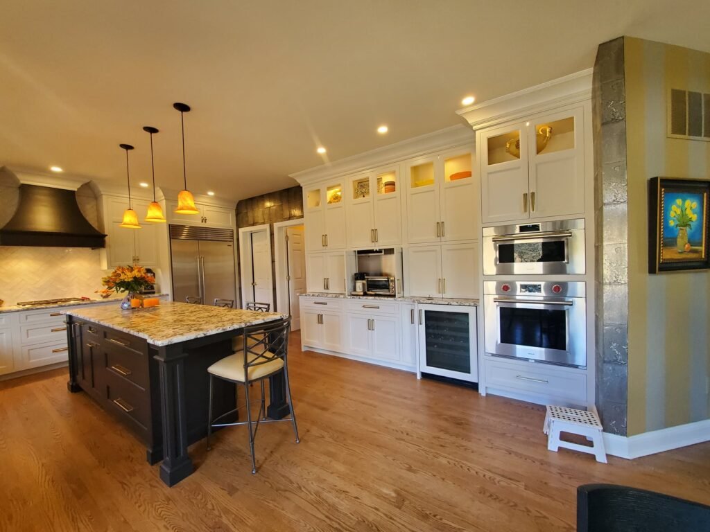 Luxury kitchen with cream cabinetry, large island, and pendant lighting designed by Choice Custom Cabinetry & Design