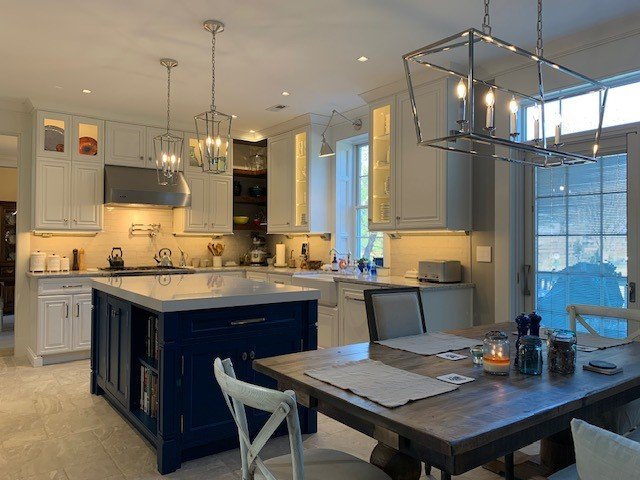 Custom kitchen in Exton, PA with white cabinetry, navy island, and modern lighting by Choice Custom Cabinetry & Design.
