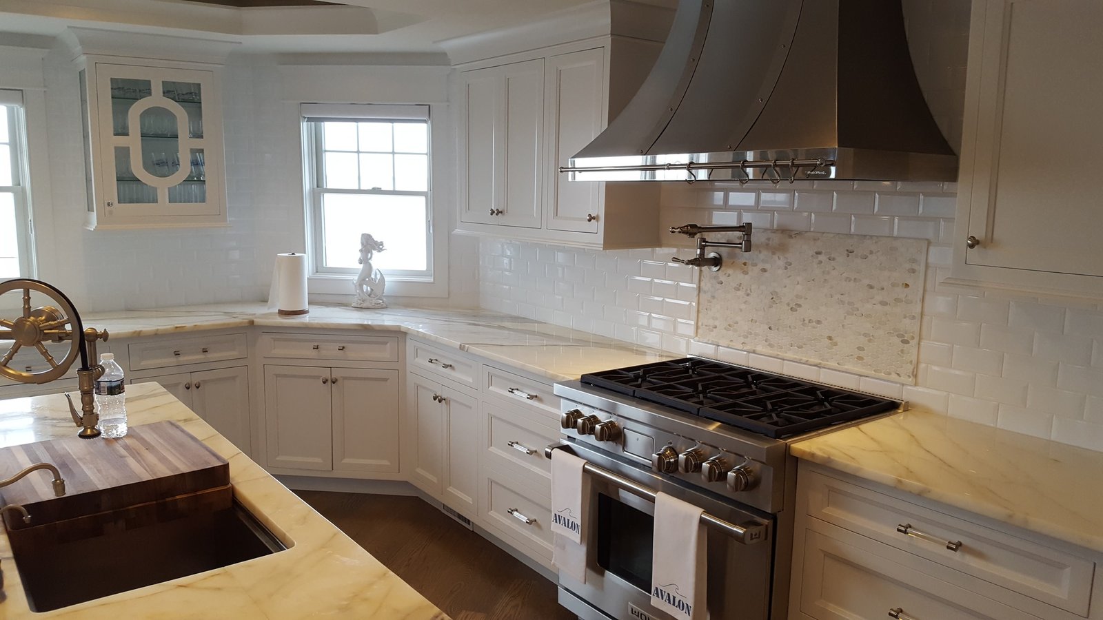 Luxury custom white kitchen with marble island and coffered ceiling by Choice Custom Cabinetry & Design in Pennsylvania.