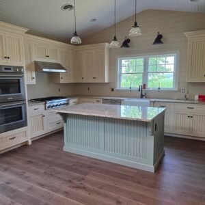 Soft-green transitional kitchen with beadboard cabinetry, quartz countertop, and custom Amish craftsmanship by Choice Custom Cabinetry & Design, Pennsylvania.