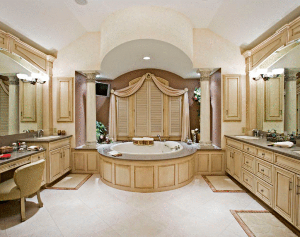 Custom traditional master bathroom with handcrafted vanities, columns, and arched tub alcove by Custom Woodworking Cabinetry & Design in Philadelphia.