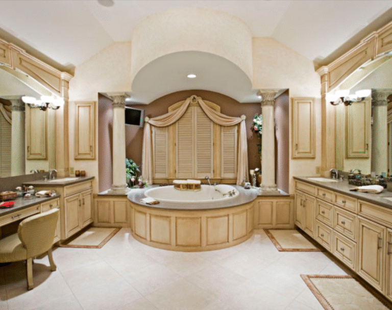 Custom traditional master bathroom with handcrafted vanities, columns, and arched tub alcove by Custom Woodworking Cabinetry & Design in Philadelphia.