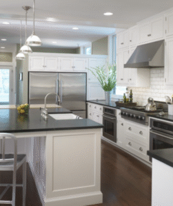 Modern farmhouse kitchen with white custom cabinetry, dark countertops, and stainless-steel appliances by Choice Custom Cabinetry & Design, Pennsylvania.