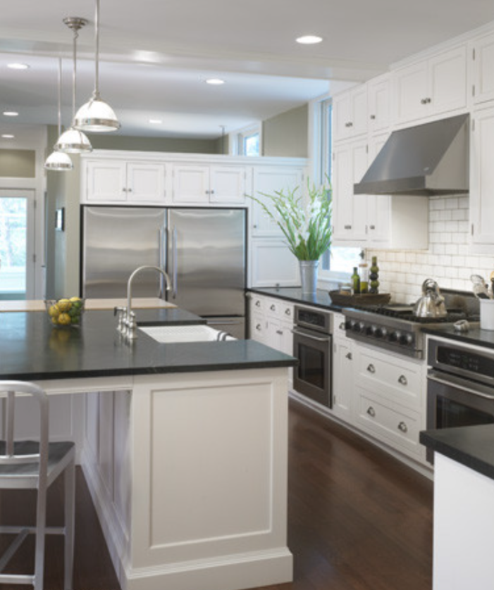 Modern farmhouse kitchen with white custom cabinetry, dark countertops, and stainless-steel appliances by Choice Custom Cabinetry & Design, Pennsylvania.