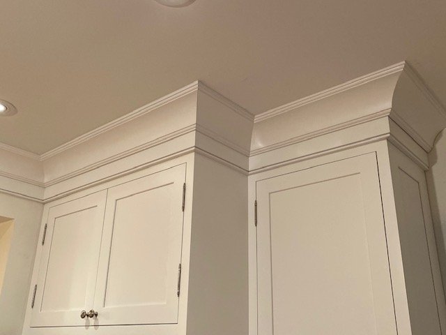 Custom white shaker cabinetry detail with quality hardware