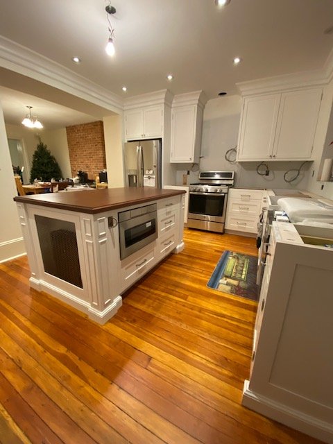 Elegant white custom kitchen with marble and inset cabinetry