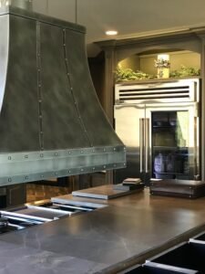 modern rustic kitchen with custom metal hood and Amish-built cabinets