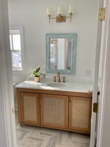 Coastal bathroom with freestanding vintage bathtub and double vanity