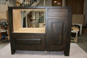 Custom dark wood kitchen island with drawers and cabinet, handcrafted by Choice Custom Cabinetry & Design.