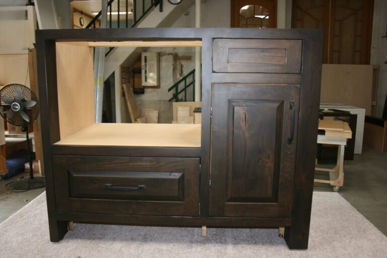 Custom dark wood kitchen island with drawers and cabinet, handcrafted by Choice Custom Cabinetry & Design.