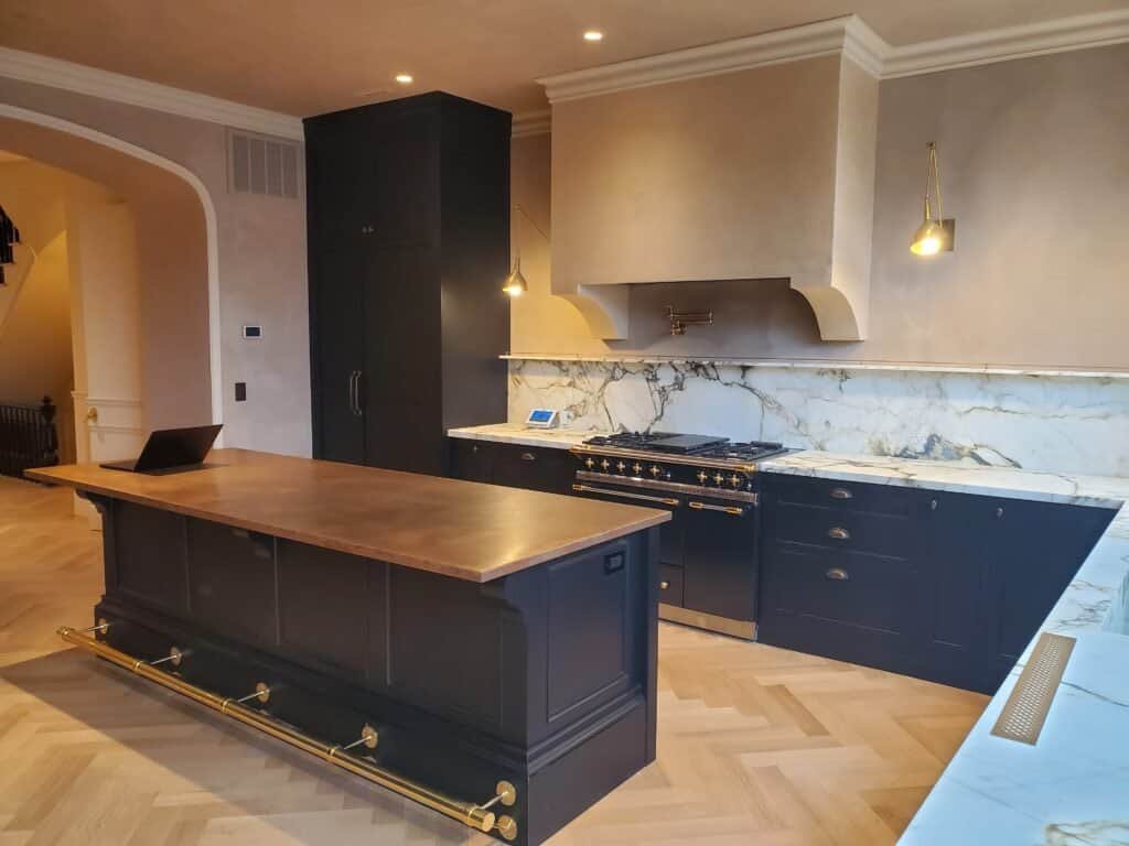 Custom dark charcoal kitchen cabinets with brass hardware and Calacatta marble, Chester County PA
