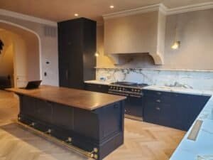 Custom dark charcoal kitchen cabinets with brass hardware and Calacatta marble, Chester County PA